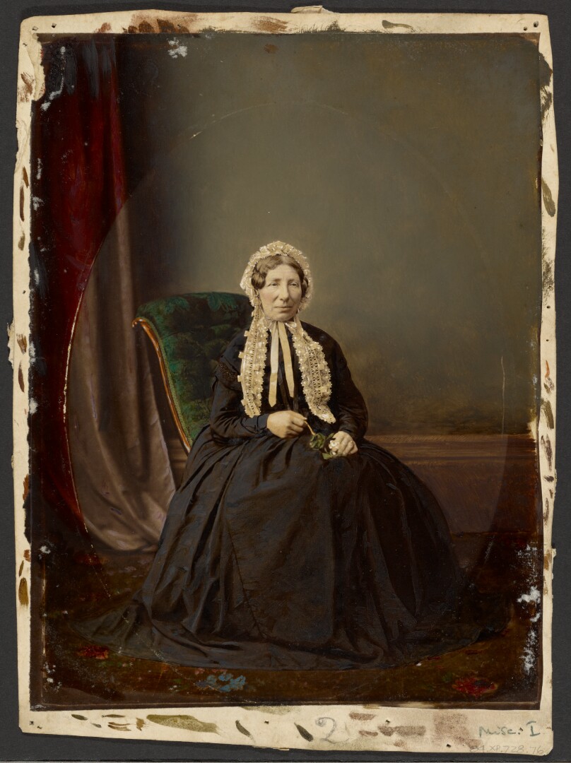 [Seated woman in bonnet]