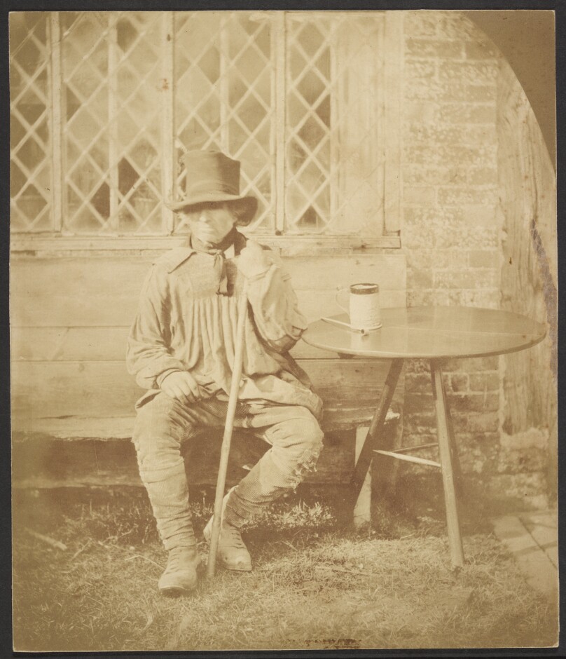 [Man seated at table]