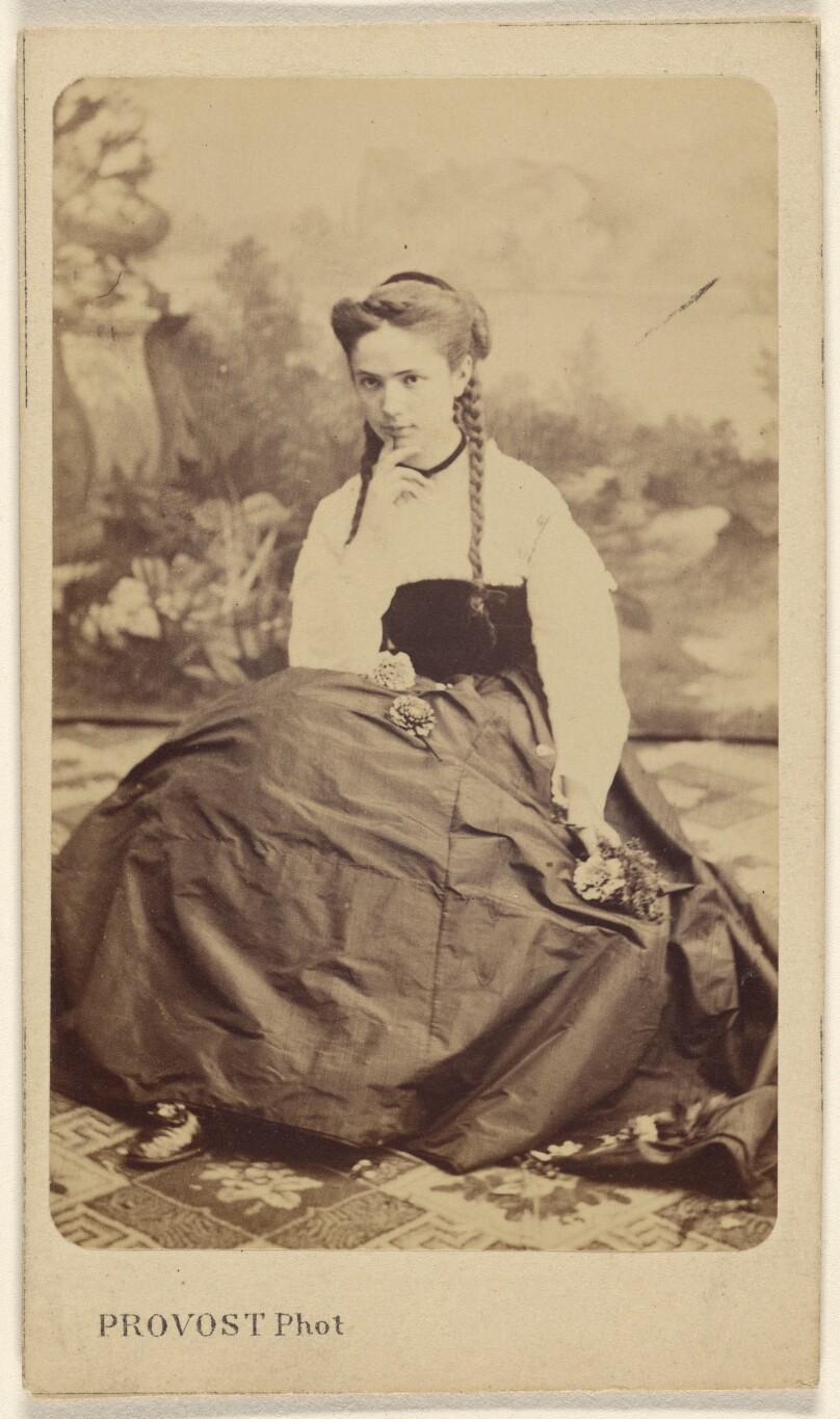[Unidentified young woman in pigtails, seated]