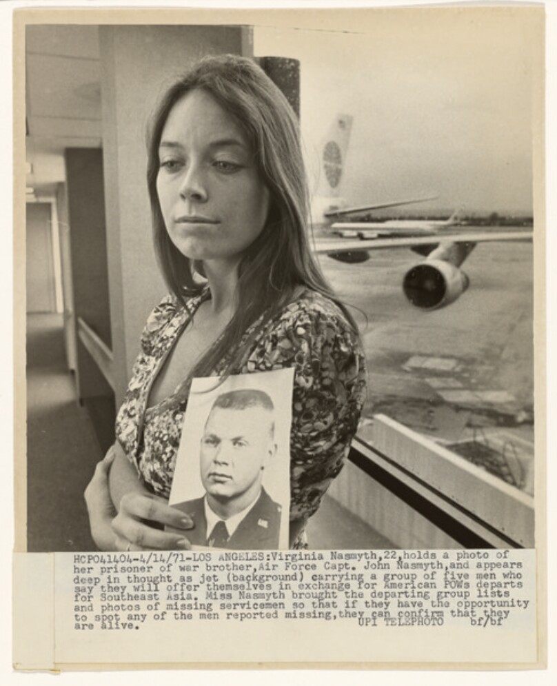 Virginia Nasmyth holding a photograph of her brother, a prisoner-of-war