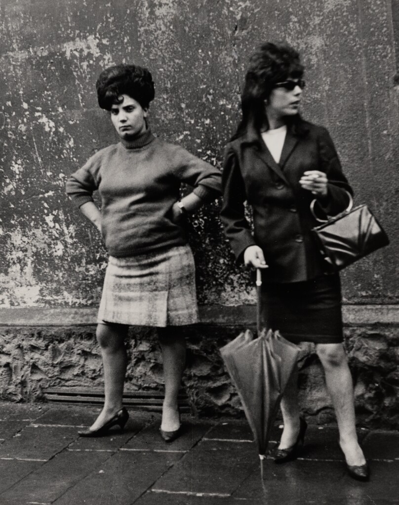 [Two women against a wall]