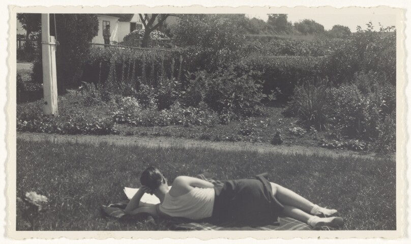 [Woman lying in the grass]