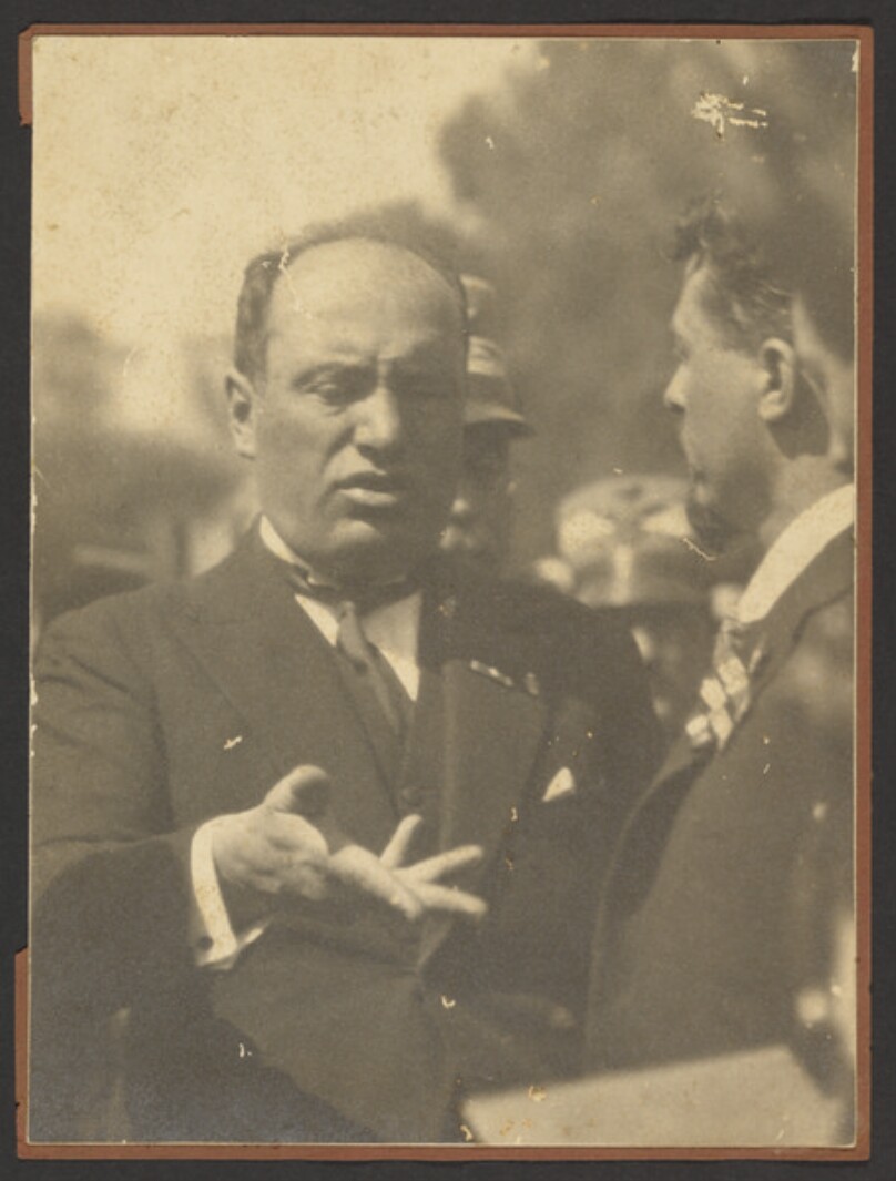 [Mussolini gesturing]