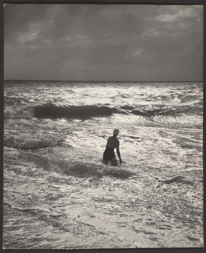 [Figure standing in ocean]