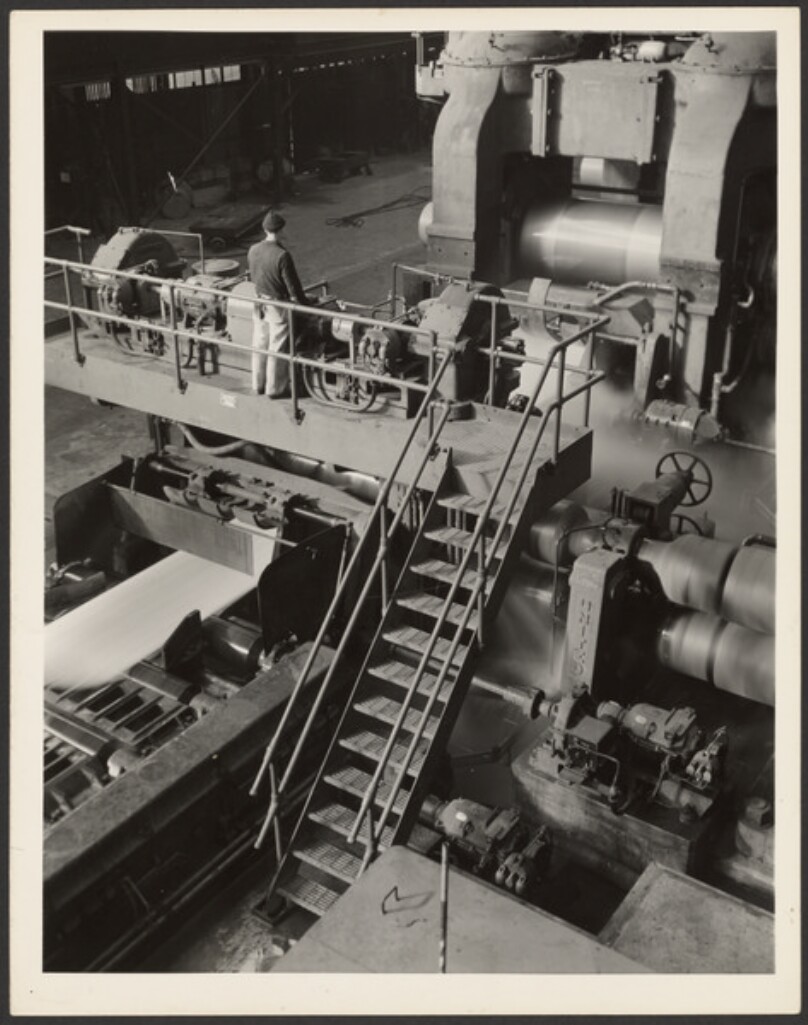Man Standing on Platform Over Machinery
