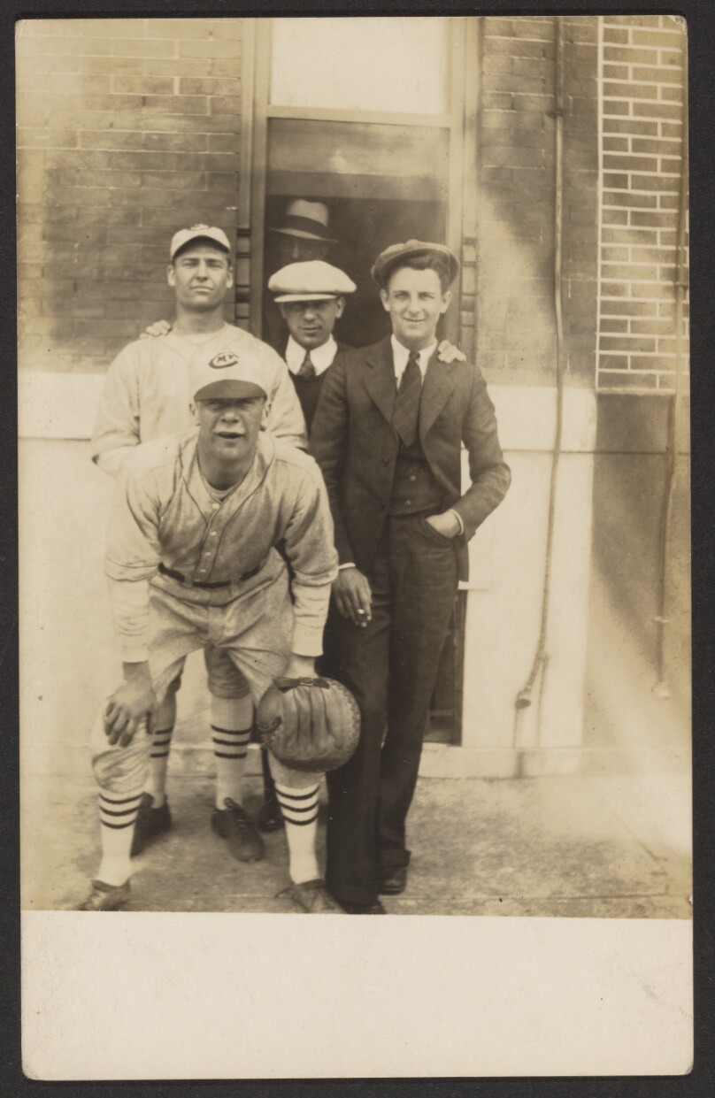 [Five men, two in baseball uniforms]