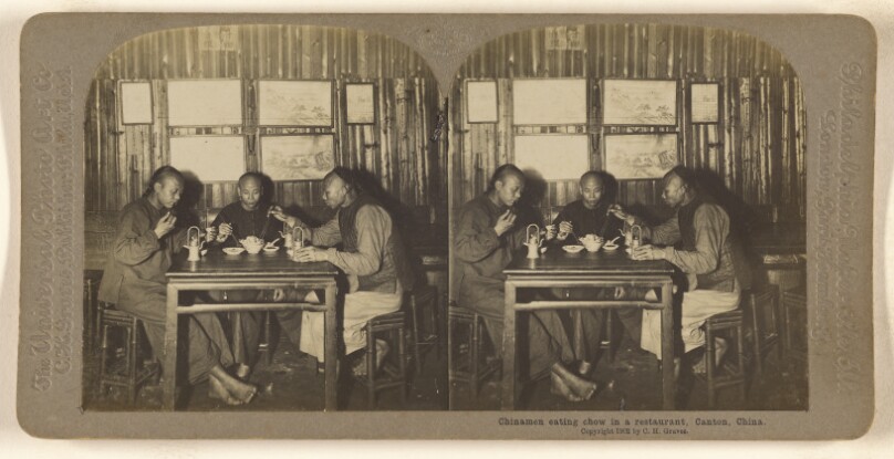 Chinamen eating chow in a restaurant. Canton, China.