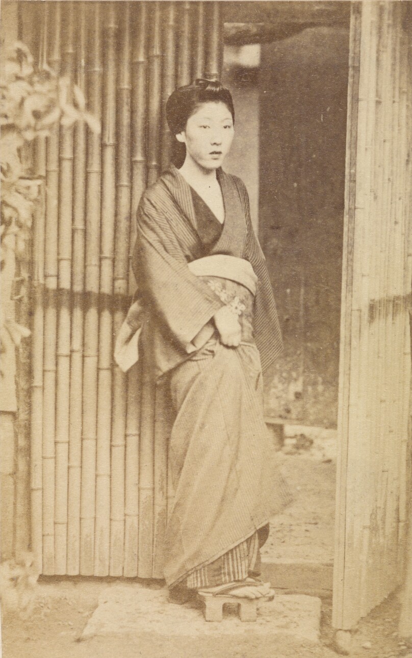 [Woman standing next to doorway]