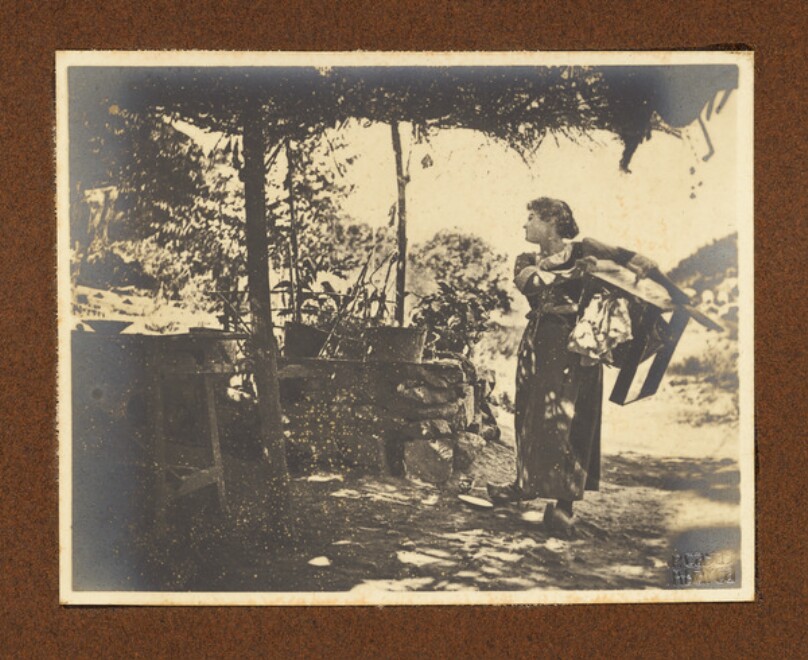 [Woman carrying laundry]