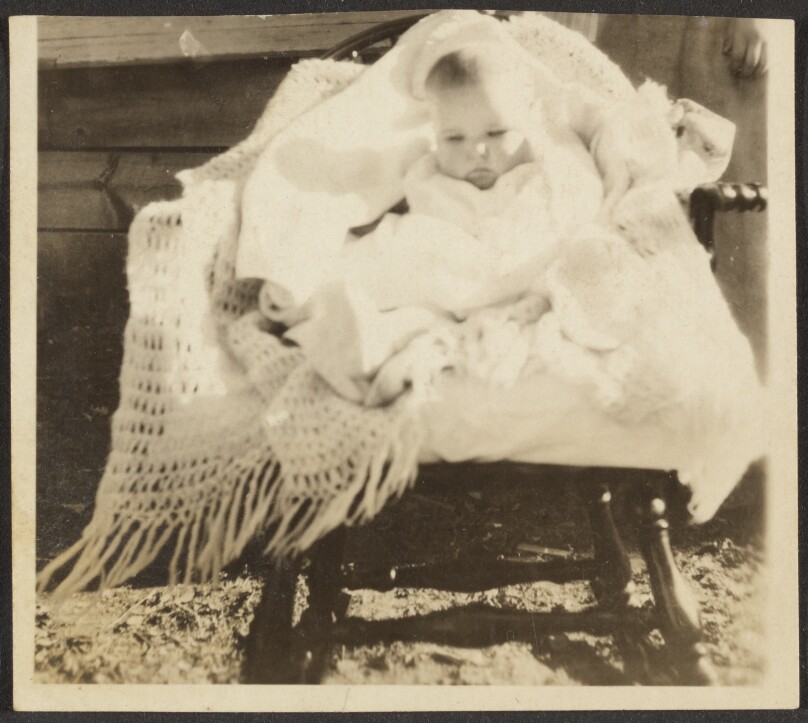 [Baby in Blankets on Rocker]