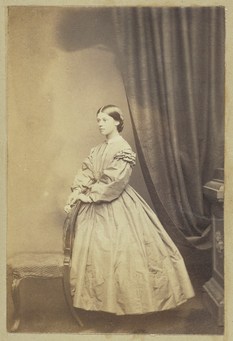 [Portrait of girl holding flower]