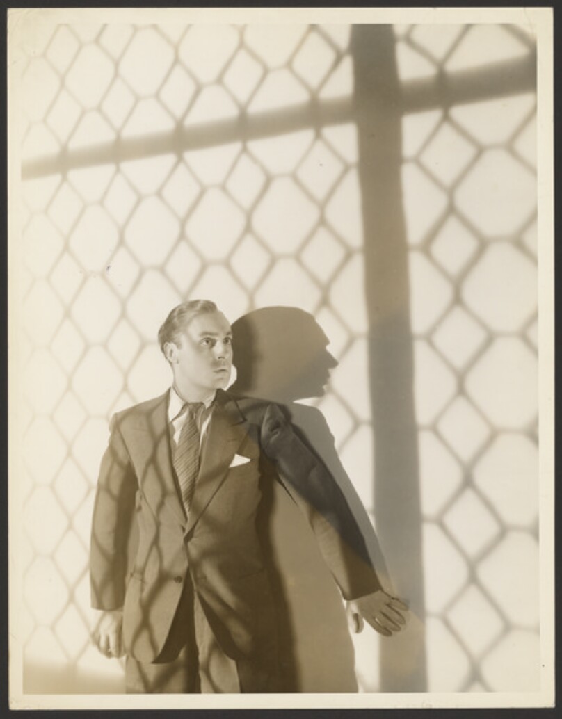 [Man against wall]