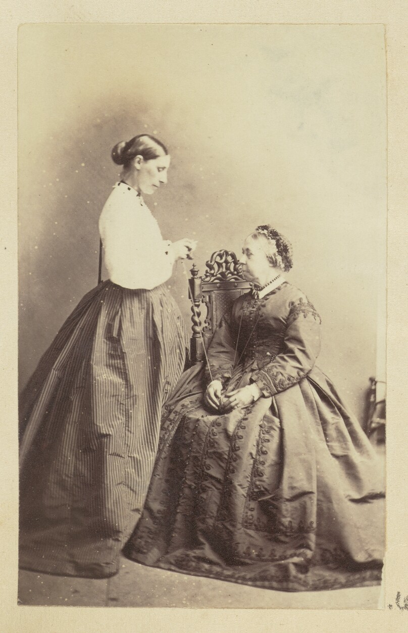 [Two women holding a ball of yarn]