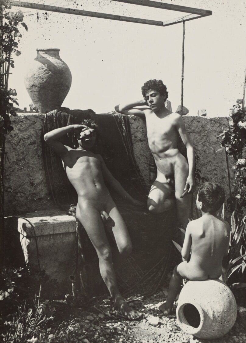 [Three boys in a garden]