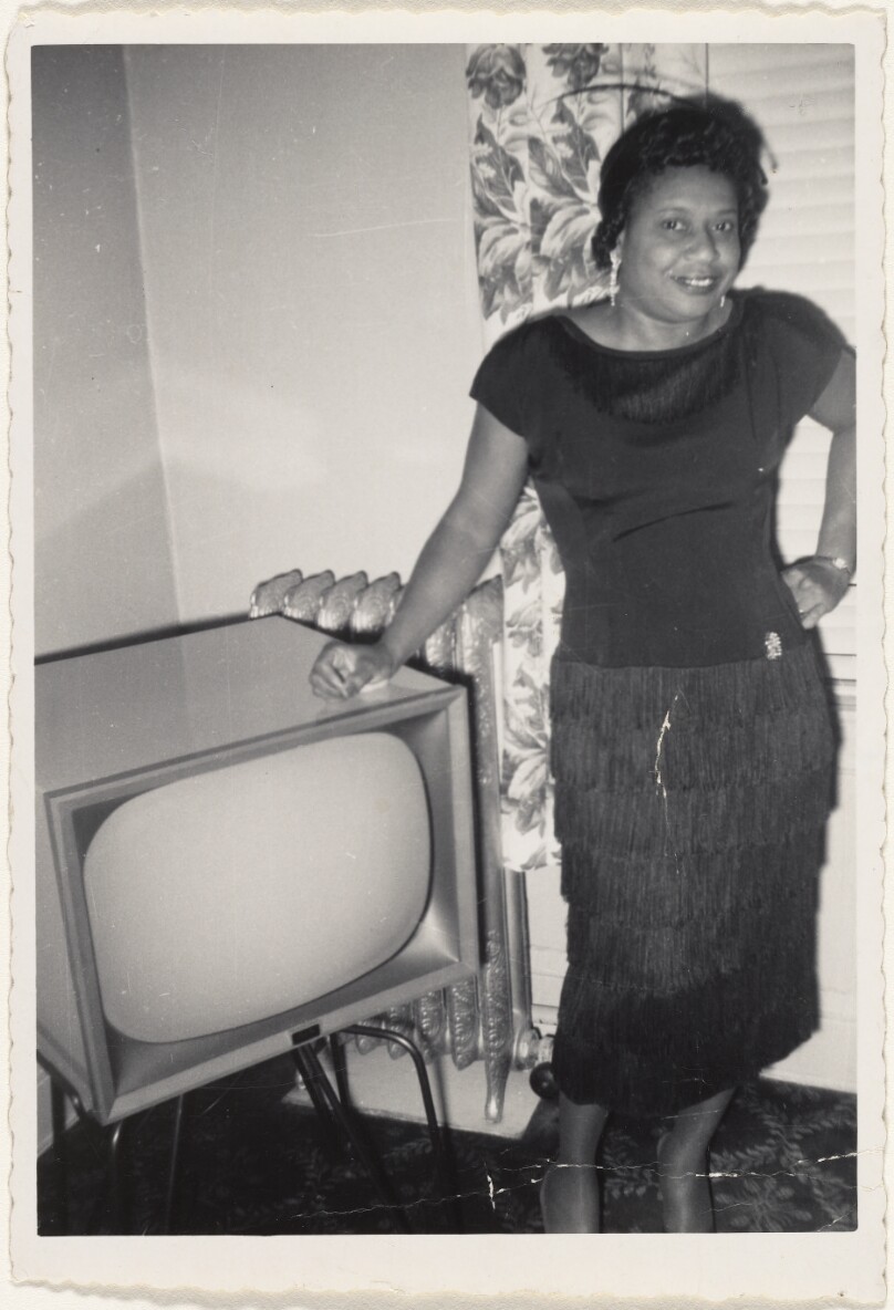 [Woman posing with television]