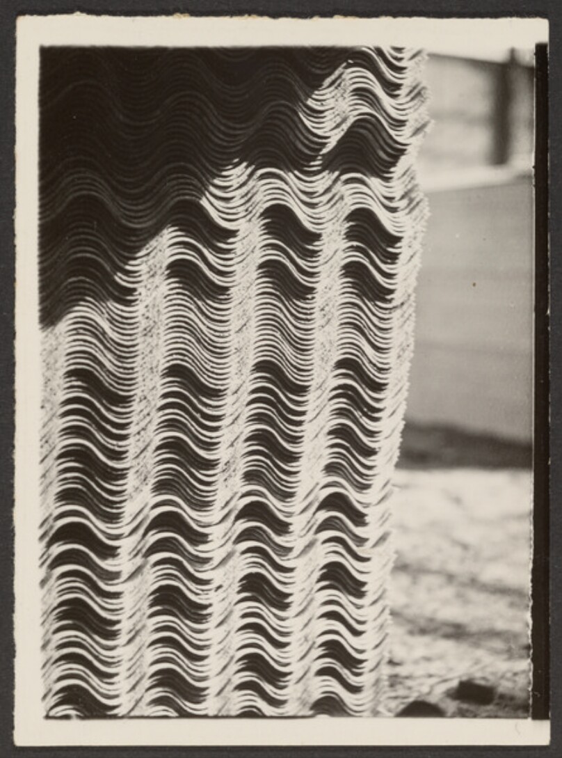 [Stack of Wavy Clay Roof Tiles]