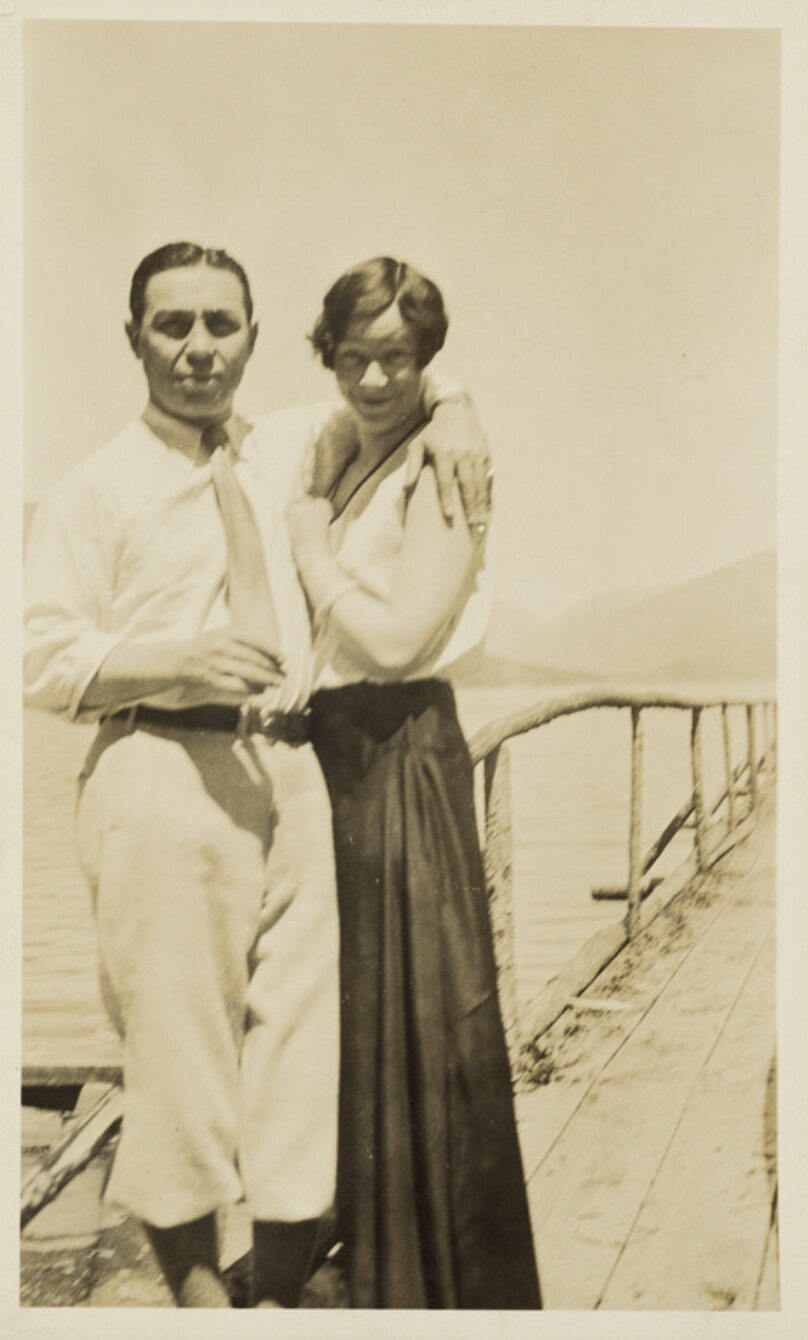 [Man and woman posed on boardwalk]