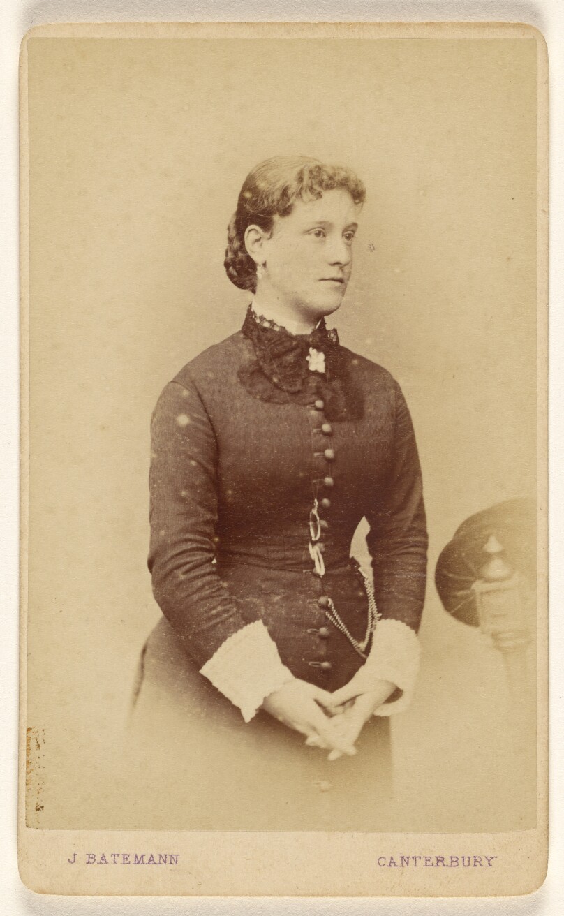 [Unidentified woman with hands together, standing]