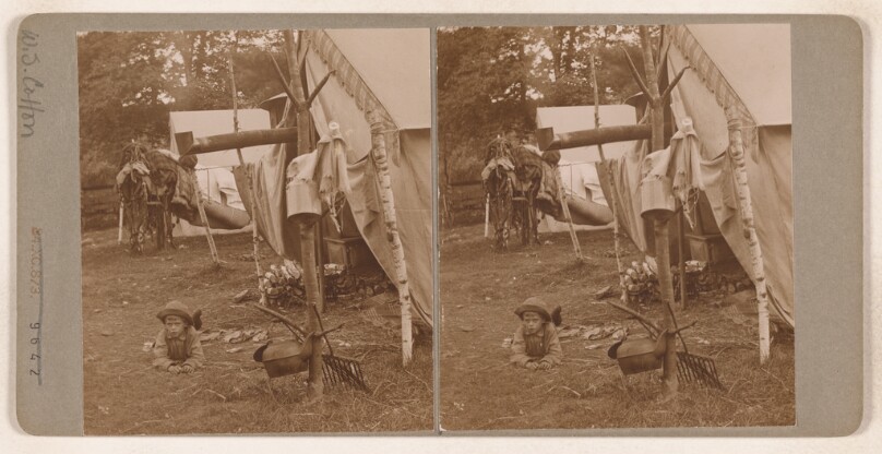 [Little boy on ground near intinerant tent set-up] (recto); [School children and teacher at entrance to school house] (verso)