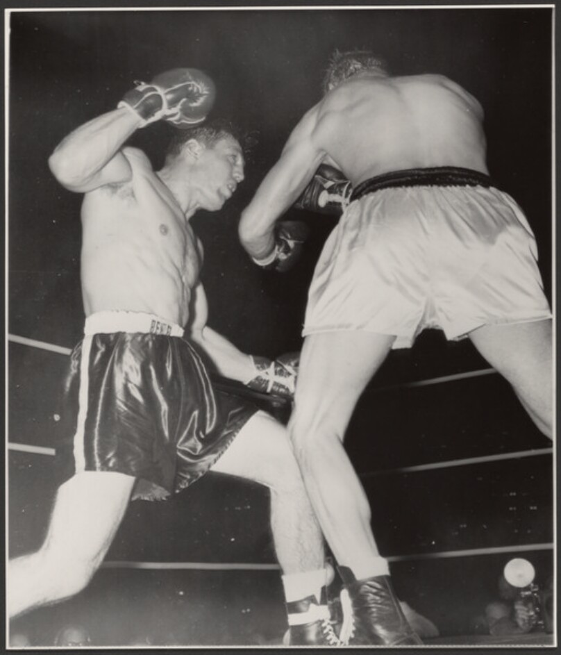 [Two boxers fighting]
