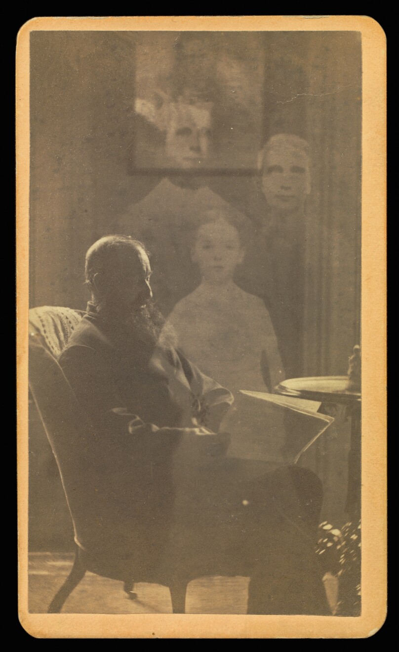[Unidentified man with a long beard seated with three "spirits"]