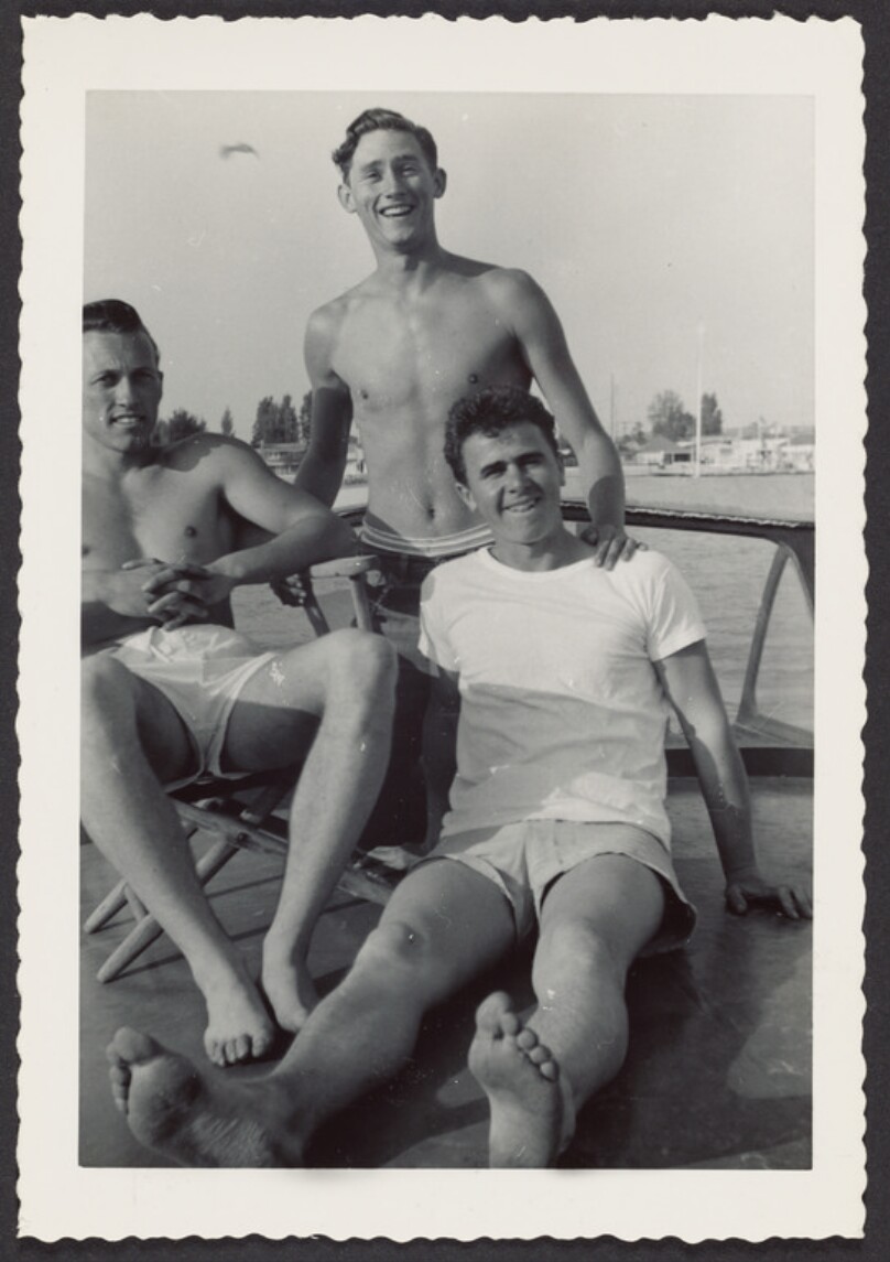 [Three young men relaxing in harbor]