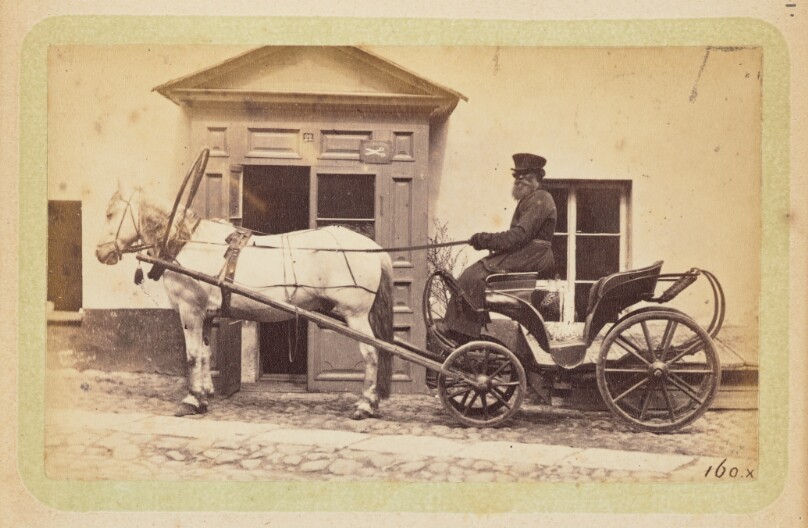 [Man driving horse-drawn carriage]