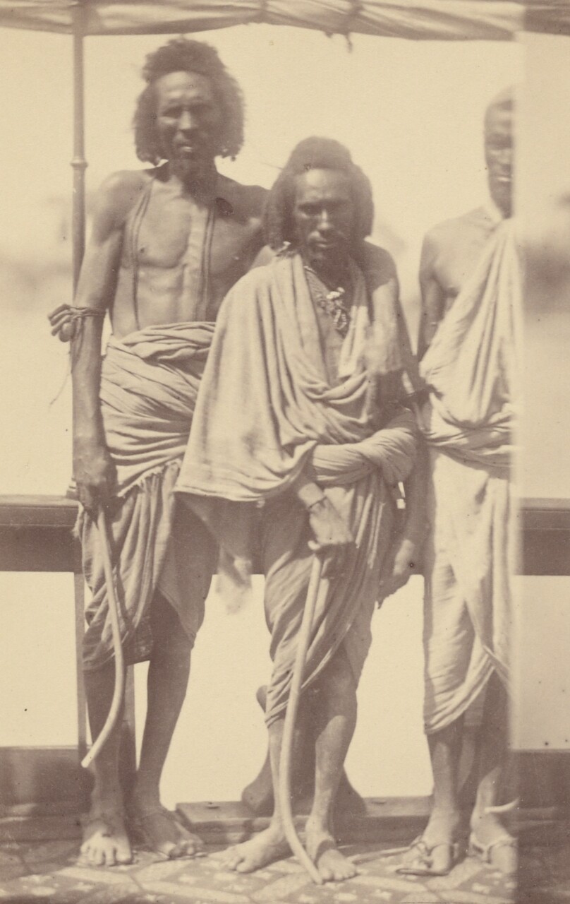 [Three North African Men Standing on a Boat]