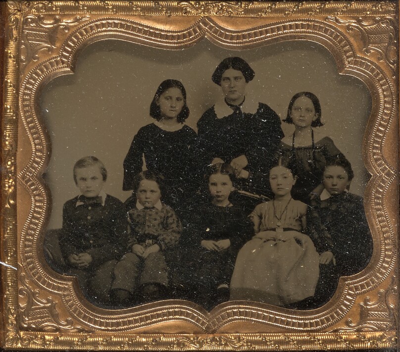 [Group portrait of a woman with seven children]