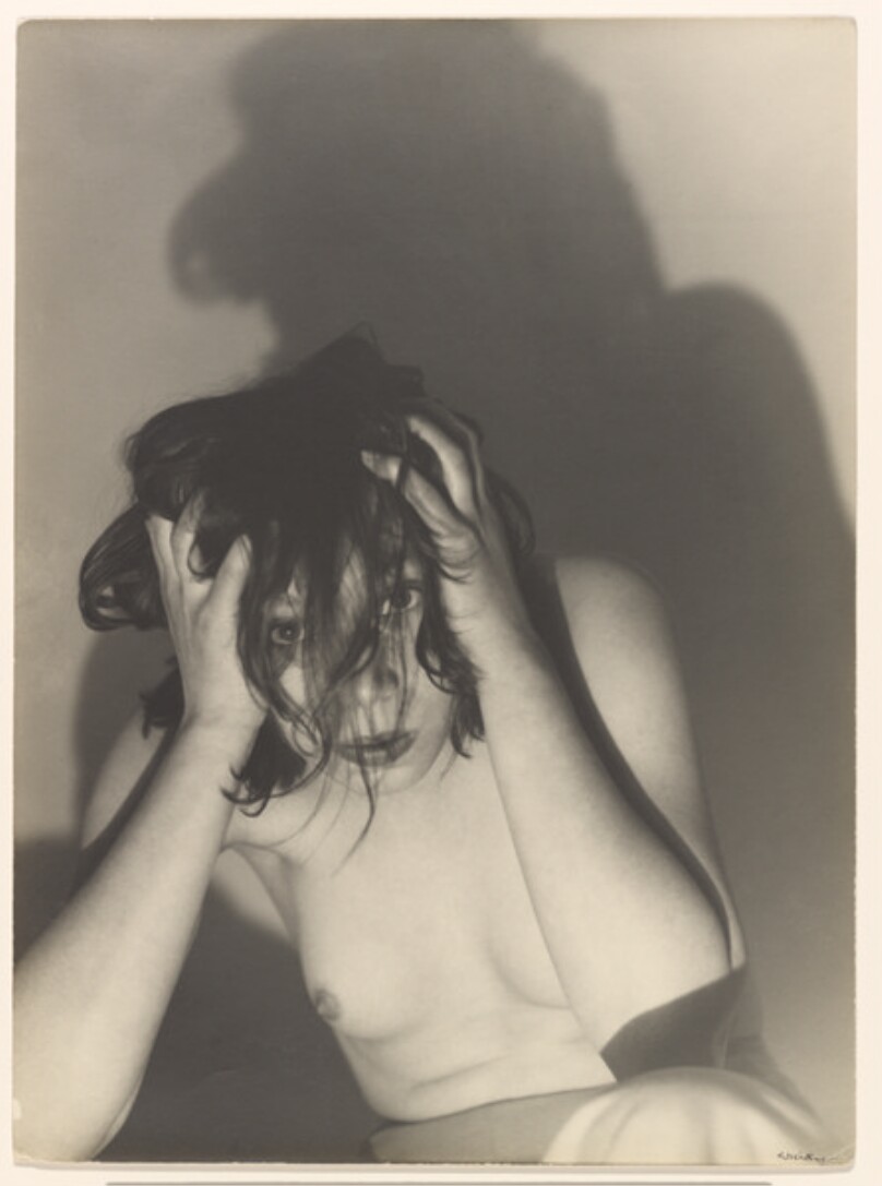 [Portrait of a woman, hands on head]