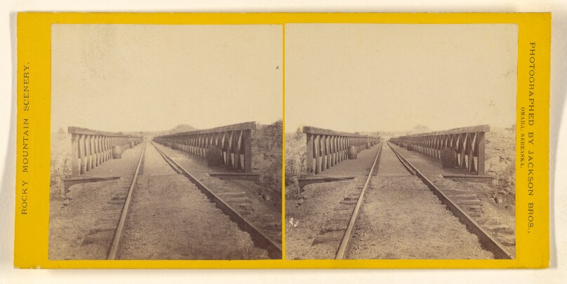 [Train tracks, angled view with trestle railings]