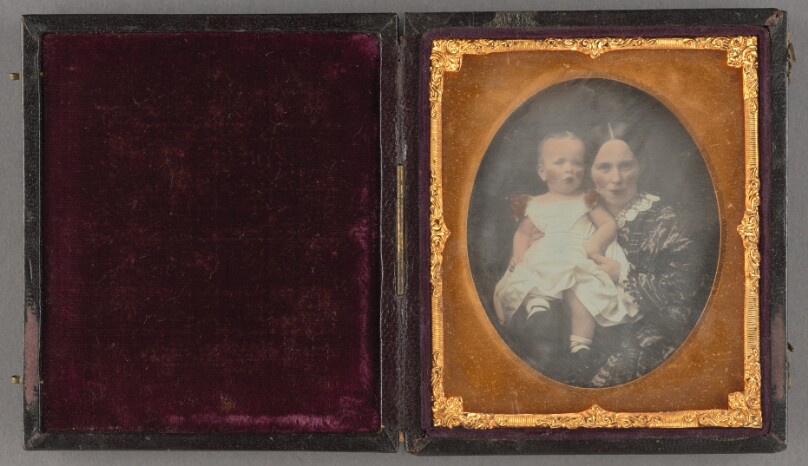 [Portrait of a woman holding a baby]