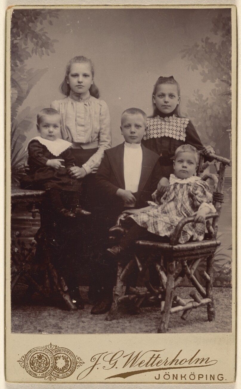 [Five children in a studio setting]