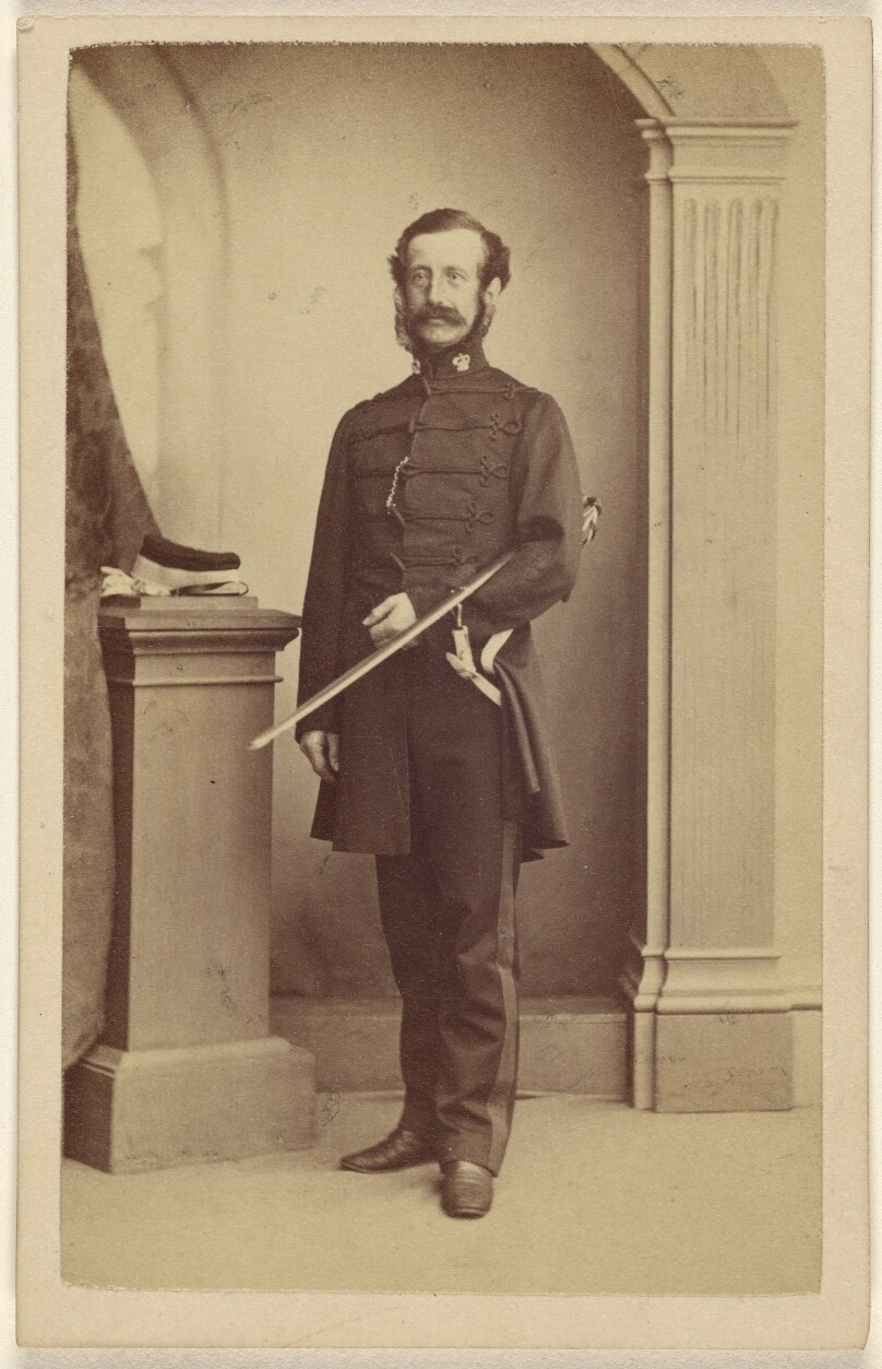 [Unidentified bearded British soldier with sword under his left arm, standing]