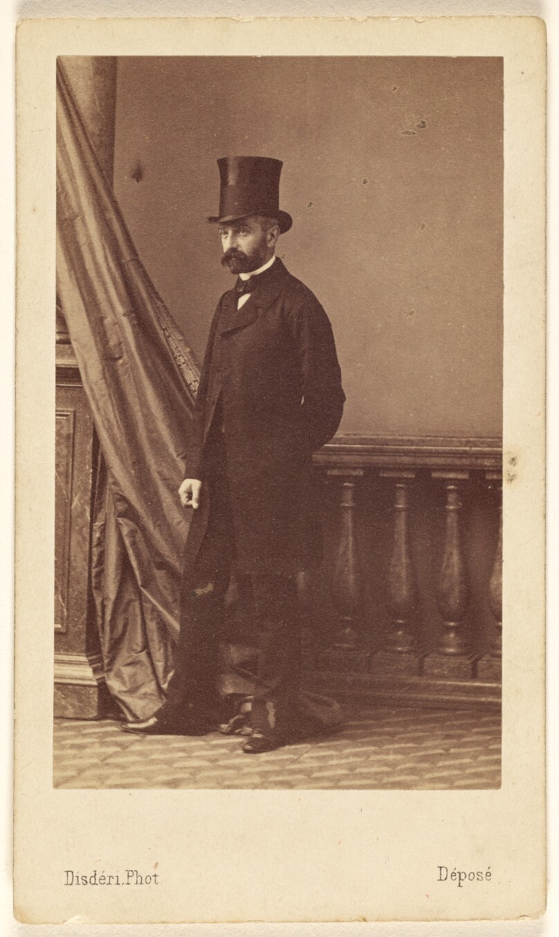 [Unidentified bearded man wearing a top hat, standing]