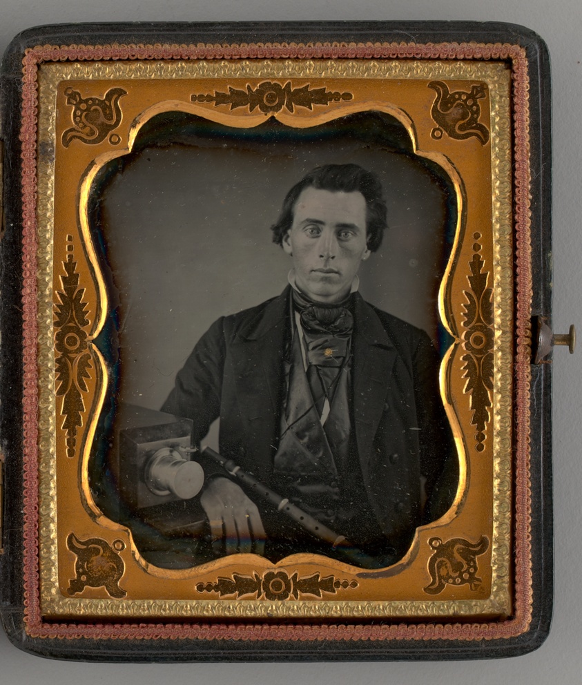 Untitled (Portrait of a Seated Man with a Camera)
