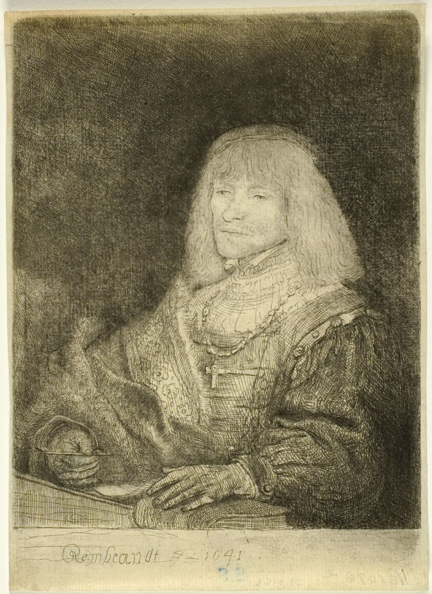 Man at a Desk Wearing a Cross and Chain