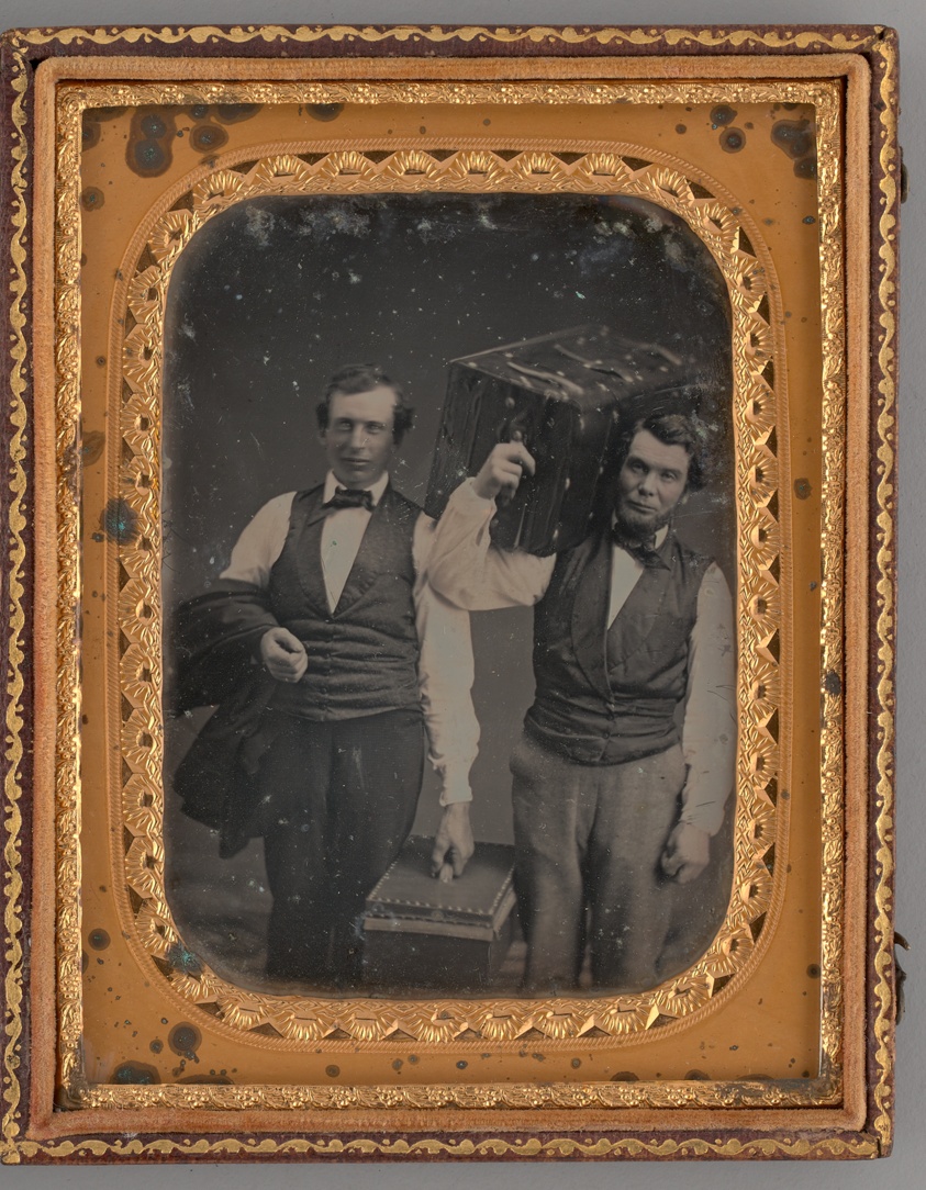 Untitled (Portrait of Two Standing Men Carrying Trunks)