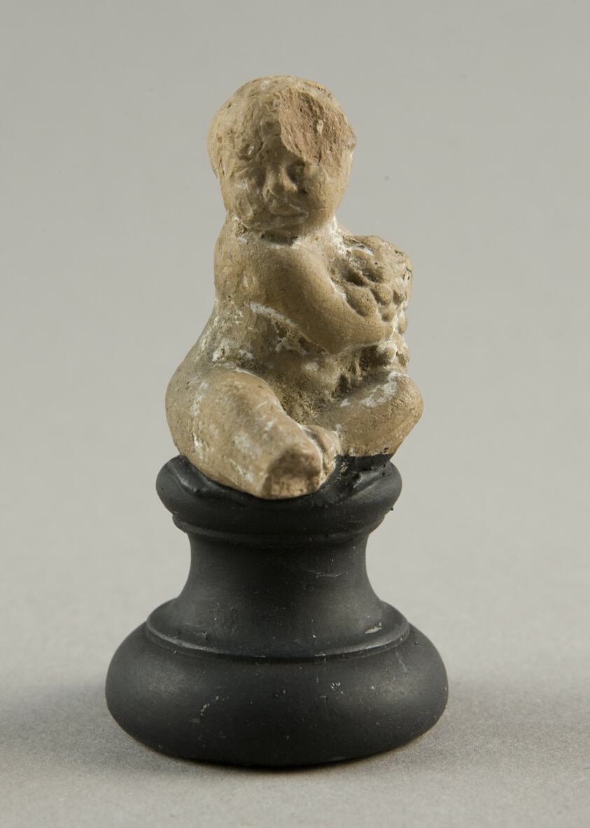Seated Child Holding Grapes