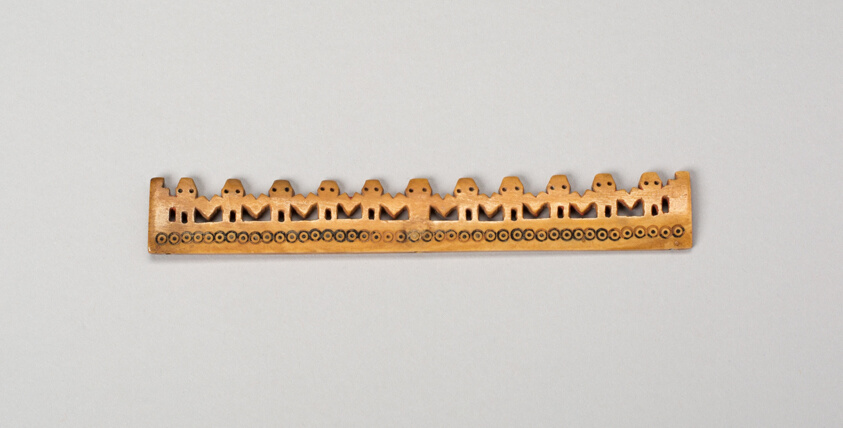 Balance-Beam Scale with Row of Cut-Out Figures and Incised Circles