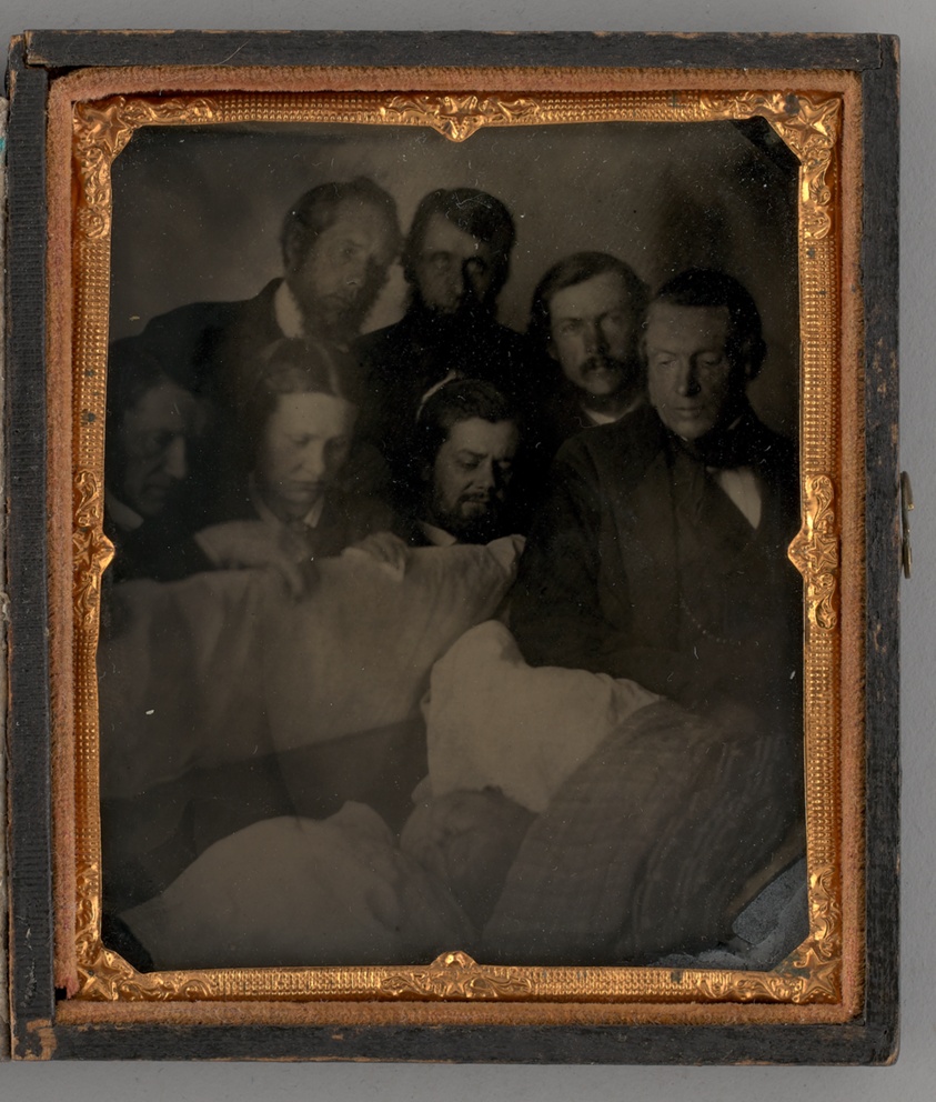 Untitled (People Standing Around a Open Casket)